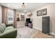 This cozy living room offers a couch, shelves, decorative lighting and hardwood floors at 4820 Valley Stream Rd, Charlotte, NC 28209