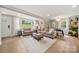 Open-concept living space with hardwood floors, comfortable seating, and a dining area with natural light at 4820 Valley Stream Rd, Charlotte, NC 28209