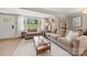 Sunlit living room boasts stylish furnishings, large windows, and a comfortable atmosphere at 4820 Valley Stream Rd, Charlotte, NC 28209