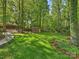 Picturesque backyard with lush landscaping, mature trees, and a storage shed at 4830 Broad Hollow Dr, Charlotte, NC 28226
