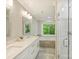 Elegant bathroom with double vanity, soaker tub and glass-enclosed shower at 4830 Broad Hollow Dr, Charlotte, NC 28226