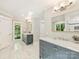 This bathroom has gray cabinets, marble countertops, and nice natural lighting at 4830 Broad Hollow Dr, Charlotte, NC 28226