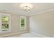 Neutral bedroom with natural light and a view of lush greenery from its windows at 4830 Broad Hollow Dr, Charlotte, NC 28226