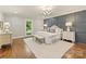 Spacious bedroom features hardwood floors, natural light, and an accent wall at 4830 Broad Hollow Dr, Charlotte, NC 28226