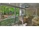 Inviting covered patio featuring outdoor seating, stone floors and backyard views at 4830 Broad Hollow Dr, Charlotte, NC 28226