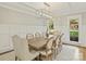 Elegant dining room with modern chandelier, paneled walls, and seating for eight guests at 4830 Broad Hollow Dr, Charlotte, NC 28226