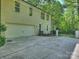 Spacious driveway leading to a garage and fenced yard with mature trees at 4830 Broad Hollow Dr, Charlotte, NC 28226