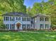 Charming two-story home with grey brick, black shutters, and a well-manicured lawn at 4830 Broad Hollow Dr, Charlotte, NC 28226