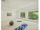 Bright and airy home gym with a view of lush greenery from its large windows at 4830 Broad Hollow Dr, Charlotte, NC 28226