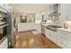 Modern kitchen featuring a large island, stainless steel appliances, and views of the living room at 4830 Broad Hollow Dr, Charlotte, NC 28226