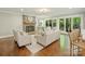 Cozy living room featuring a stone fireplace, hardwood floors, and comfortable seating at 4830 Broad Hollow Dr, Charlotte, NC 28226