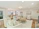 Open-concept living room with hardwood floors and comfortable seating area near kitchen at 4830 Broad Hollow Dr, Charlotte, NC 28226
