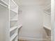 A walk-in closet featuring built-in shelving and ample storage space at 4830 Broad Hollow Dr, Charlotte, NC 28226