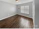 Bright bedroom with wood floors, neutral walls, and a window, creating a versatile space at 4906 Lynn Lee Cir, Charlotte, NC 28269