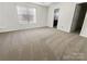 Carpeted bedroom featuring a large window, ensuite bathroom and neutral decor at 4906 Lynn Lee Cir, Charlotte, NC 28269