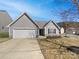Charming single-story home featuring gray siding, a well-maintained lawn, and an attached one-car garage at 4906 Lynn Lee Cir, Charlotte, NC 28269