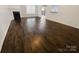 Open concept living room featuring hardwood floors, fireplace, and a seamless flow to the kitchen space at 4906 Lynn Lee Cir, Charlotte, NC 28269