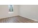 Cozy bedroom with wood-look flooring and a window providing natural light at 511 Roberts St, Shelby, NC 28150