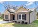 Charming single story home with tan siding, black shutters and a well manicured yard at 511 Roberts St, Shelby, NC 28150