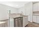 Bright kitchen with stainless steel dishwasher, undermount sink, and white cabinets at 511 Roberts St, Shelby, NC 28150