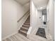 Hallway with stairs featuring plush carpeting, complemented by light walls and wood-look flooring, leading to various rooms at 522 Trading Post Ln, York, SC 29745