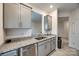 Open kitchen view with granite countertops, stainless steel dishwasher, and gray cabinetry at 522 Trading Post Ln, York, SC 29745