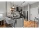 Modern kitchen featuring granite counters, stainless appliances, and stylish floating shelves at 525 E 6Th St # 211, Charlotte, NC 28202