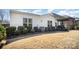 This backyard features a well-manicured lawn, patio, pergola, and white siding house at 5306 Tilley Manor Dr, Matthews, NC 28105