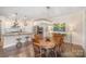 Dining area with wood table and chairs, chandelier, and open to the kitchen at 5306 Tilley Manor Dr, Matthews, NC 28105