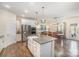 Bright kitchen with stainless steel appliances, a center island, and an adjacent dining area at 5306 Tilley Manor Dr, Matthews, NC 28105