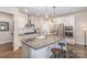 Modern kitchen with granite countertops, white cabinets, stainless steel appliances, and a breakfast bar at 5306 Tilley Manor Dr, Matthews, NC 28105