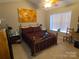 Cozy bedroom featuring a comfortable bed, bright natural light, and a ceiling fan at 5963 Moose Ln, Charlotte, NC 28269
