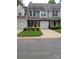 Well-kept townhome with landscaped front yard, garage, and covered entry at 5963 Moose Ln, Charlotte, NC 28269