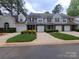 Charming townhome featuring manicured front lawn and single-car garage at 5963 Moose Ln, Charlotte, NC 28269