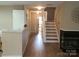 Welcoming foyer with wood floors, fireplace, and staircase at 5963 Moose Ln, Charlotte, NC 28269