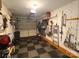 Garage featuring a checkered floor, storage system, and an open door revealing the exterior at 5963 Moose Ln, Charlotte, NC 28269