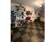 Garage with an organized wall storage system and gray, black, and white checkered floors at 5963 Moose Ln, Charlotte, NC 28269