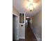 Hallway featuring hardwood floors, white walls, and a wooden staircase, leading to other rooms at 5963 Moose Ln, Charlotte, NC 28269