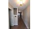 Welcoming hallway featuring wood floors and a classic lantern-style light fixture at 5963 Moose Ln, Charlotte, NC 28269