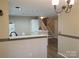 Bright kitchen showcasing a breakfast bar with a clean white countertop and staircase nearby at 5963 Moose Ln, Charlotte, NC 28269