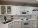 Modern kitchen with white cabinets, stainless steel sink, and updated countertops at 5963 Moose Ln, Charlotte, NC 28269