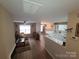 Bright living room with modern flooring and a view into the open kitchen area at 5963 Moose Ln, Charlotte, NC 28269