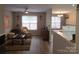 Comfortable living room featuring wood flooring, a ceiling fan, and natural light at 5963 Moose Ln, Charlotte, NC 28269