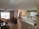 Bright and airy living room with wood floors and an open view to the updated kitchen at 5963 Moose Ln, Charlotte, NC 28269