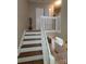 Open staircase with wood treads and white risers, offering a view of the living area at 5963 Moose Ln, Charlotte, NC 28269