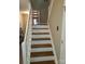 Well-lit staircase with classic wood treads and white risers and railings at 5963 Moose Ln, Charlotte, NC 28269