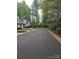 Quiet neighborhood street with mature trees, manicured lawns, and townhomes at 5963 Moose Ln, Charlotte, NC 28269
