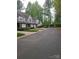 Scenic street featuring lovely townhomes nestled among mature trees and lawns at 5963 Moose Ln, Charlotte, NC 28269