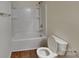 Well-lit bathroom with a bathtub and toilet, showcasing a clean design at 600 Hunley St, Monroe, NC 28112