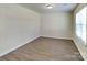 Bright bedroom features wood-look flooring and natural light from the large window at 600 Hunley St, Monroe, NC 28112